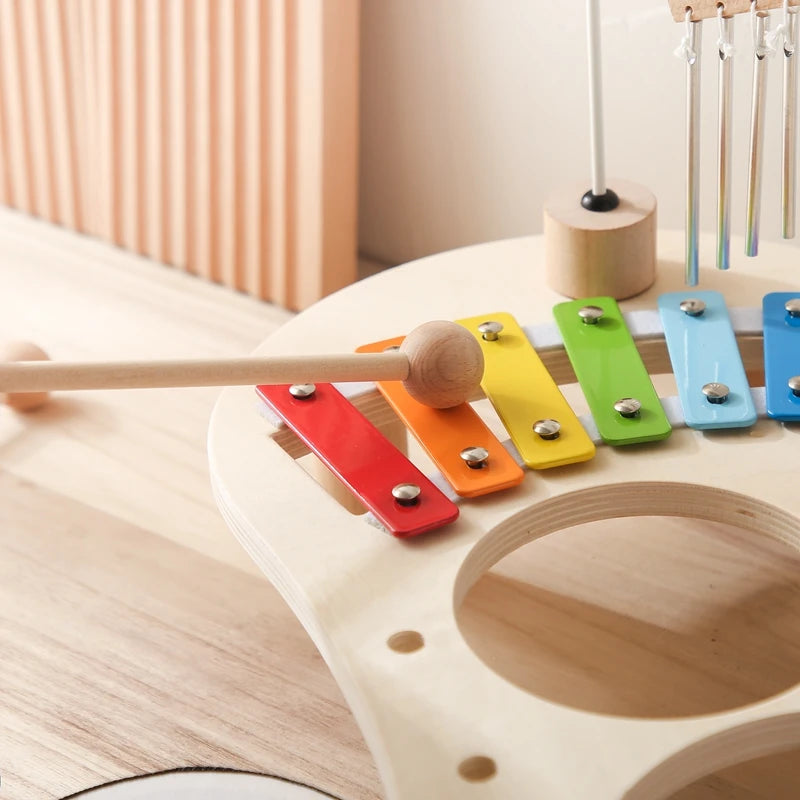 Colorful wooden xylophone for kids with mallet on light wood table