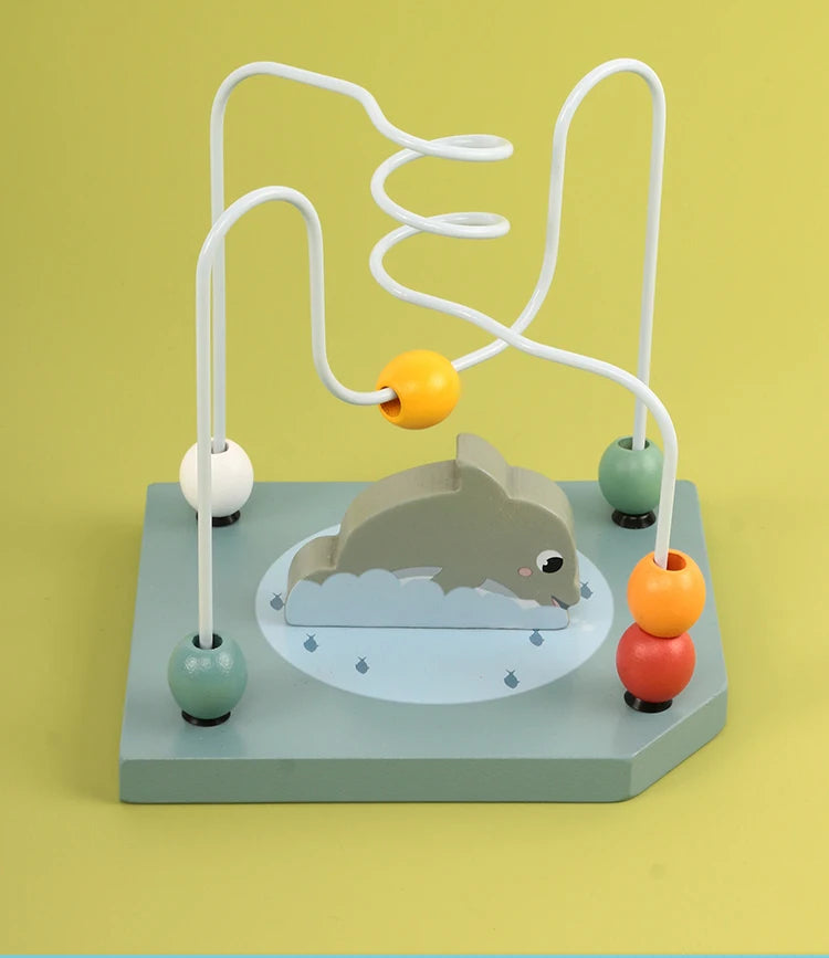 Wooden bead maze toy with dolphin design and colorful beads on green background