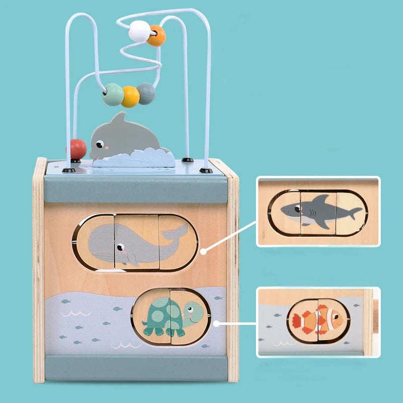 Wooden activity cube toy with sea animal sliders, bead maze, whale, and turtle illustrations